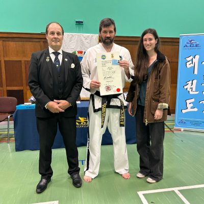 Mr Anthony Harris showing his 5th Dan certificate