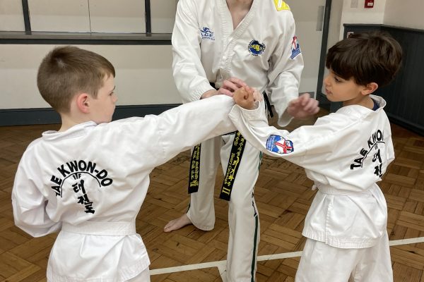 Henry Cavanagh teaching white belts how to spar